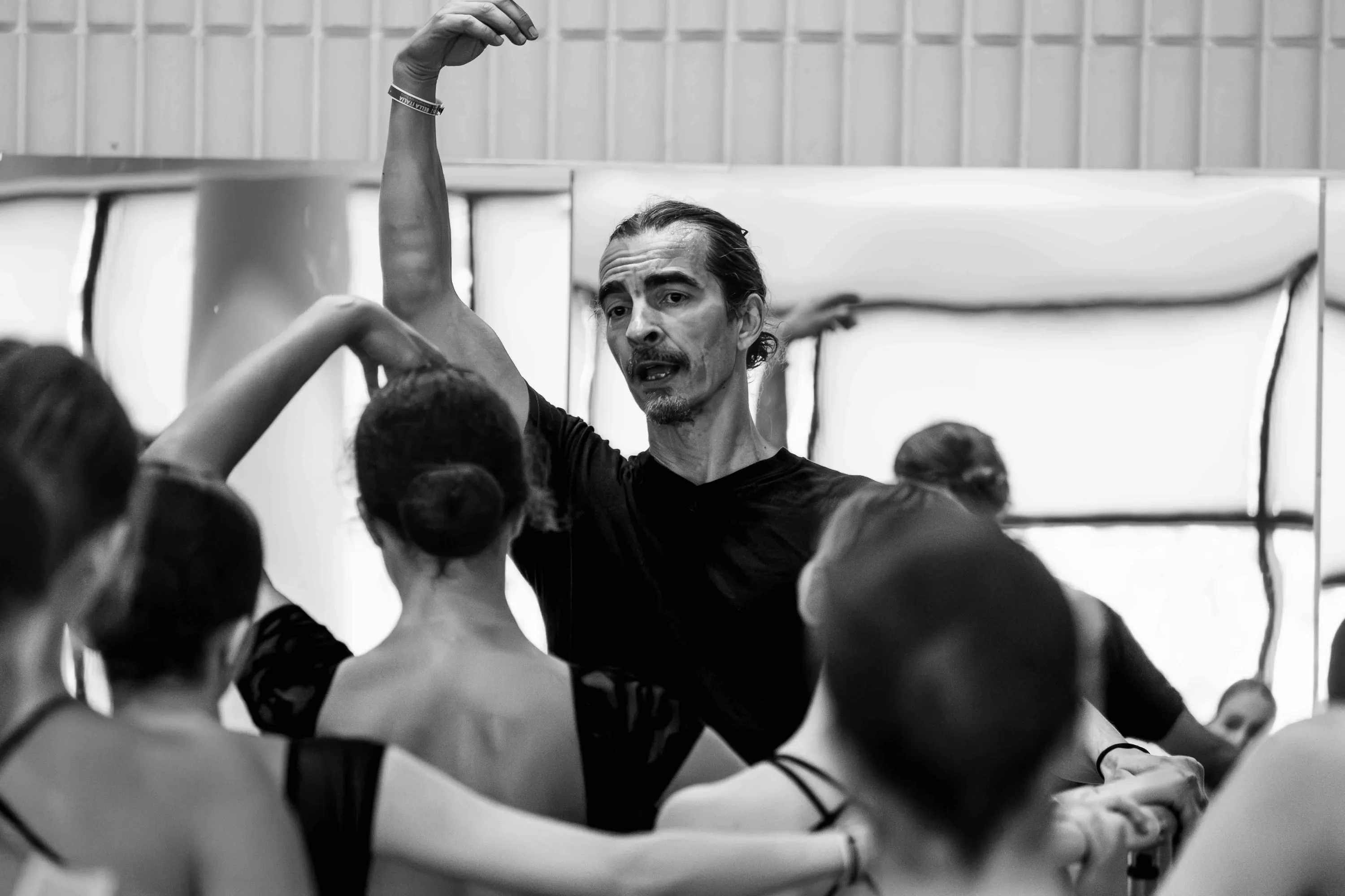 The teacher with his arm raised among the students
