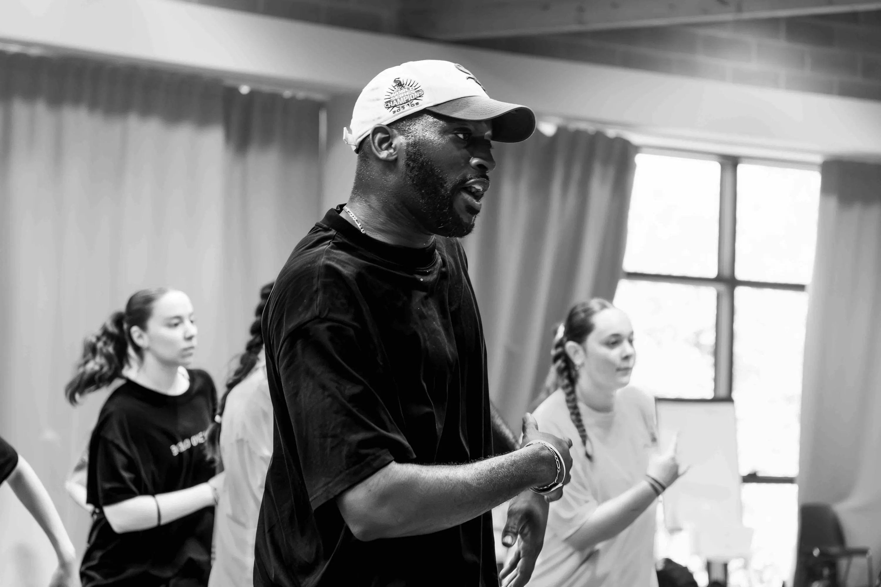 The teacher in a cap follows the students' movement