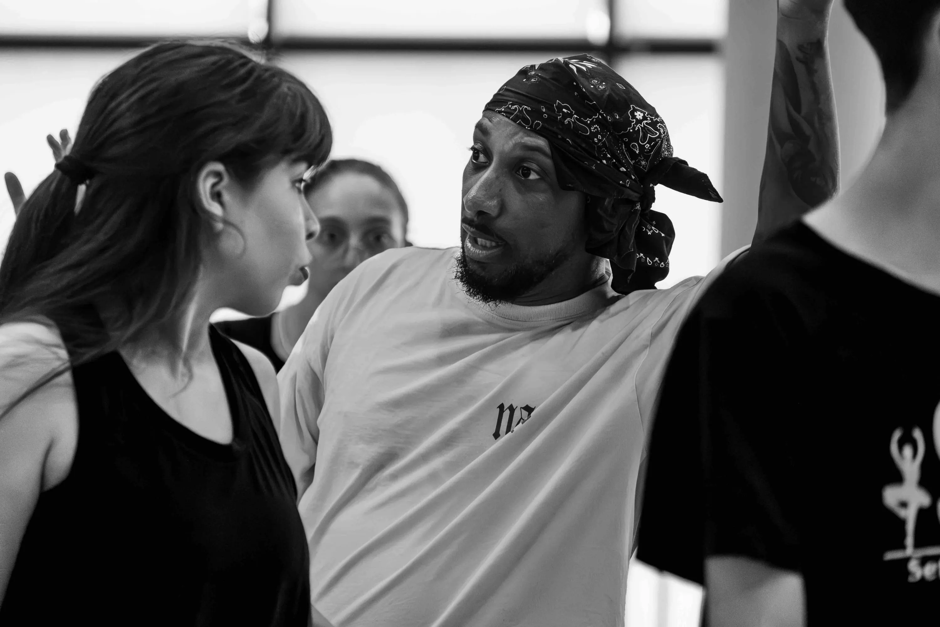 The teacher in a bandana talks with a student
