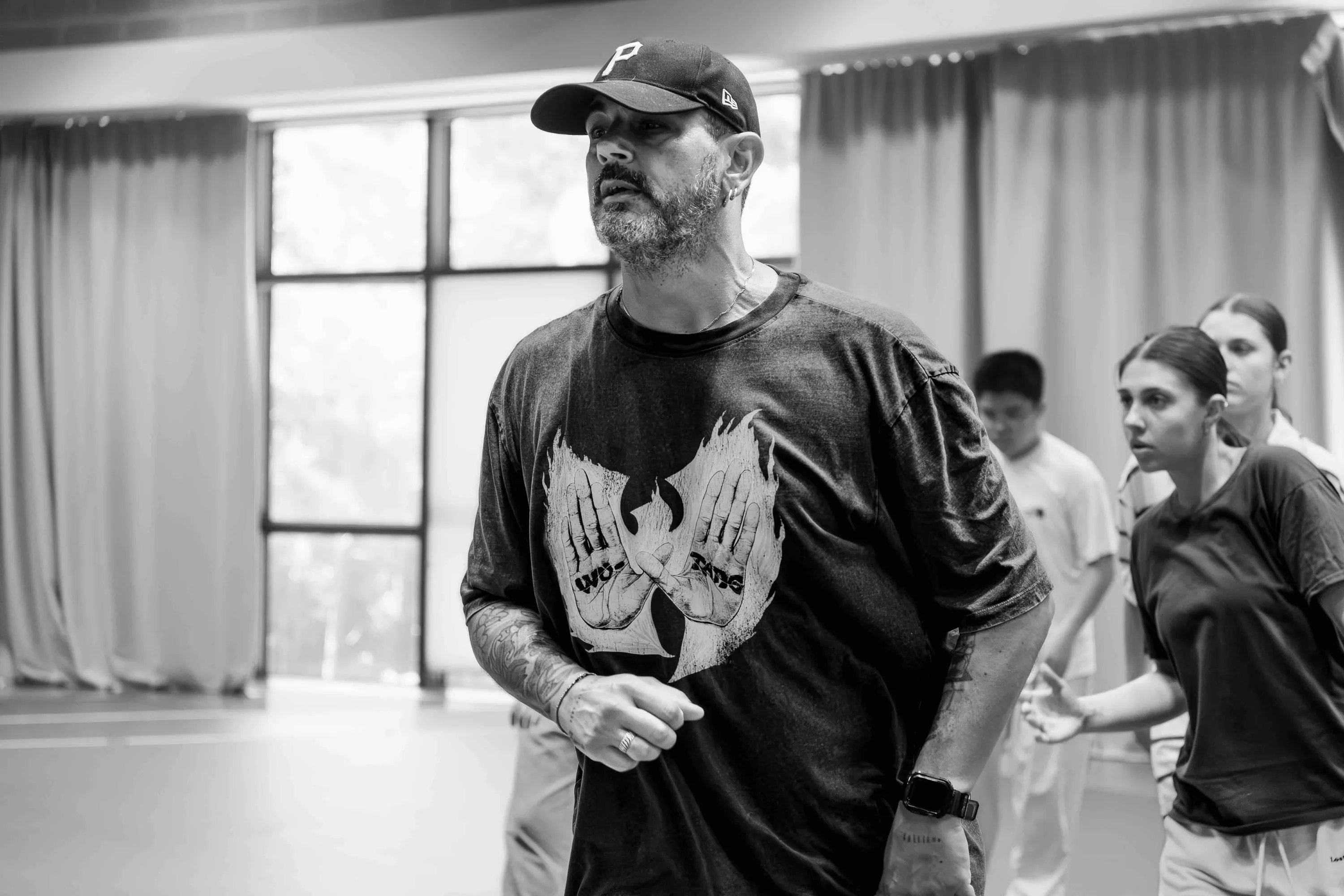 The teacher in a cap watches the students move