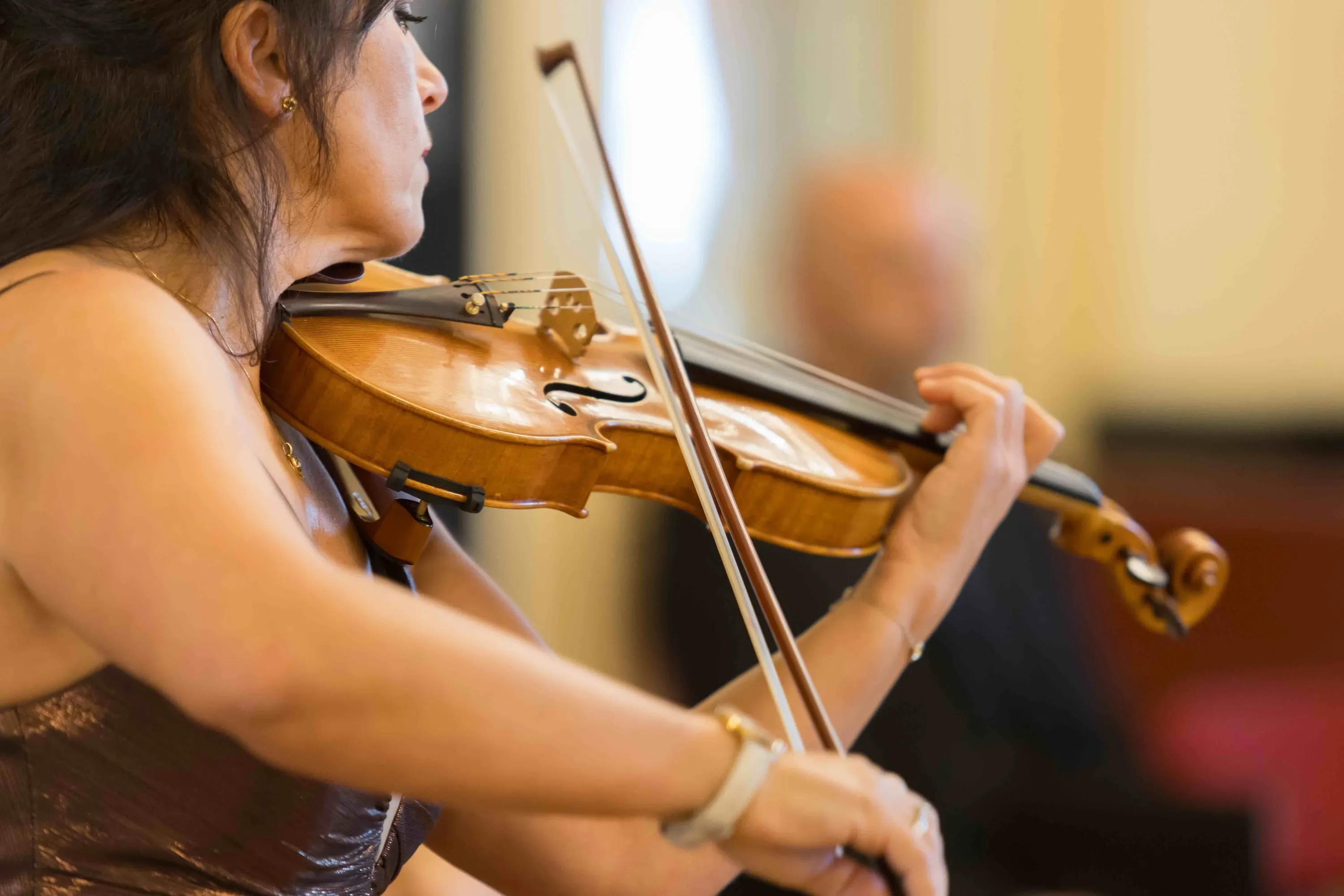 A violinist playing, seen in close profile