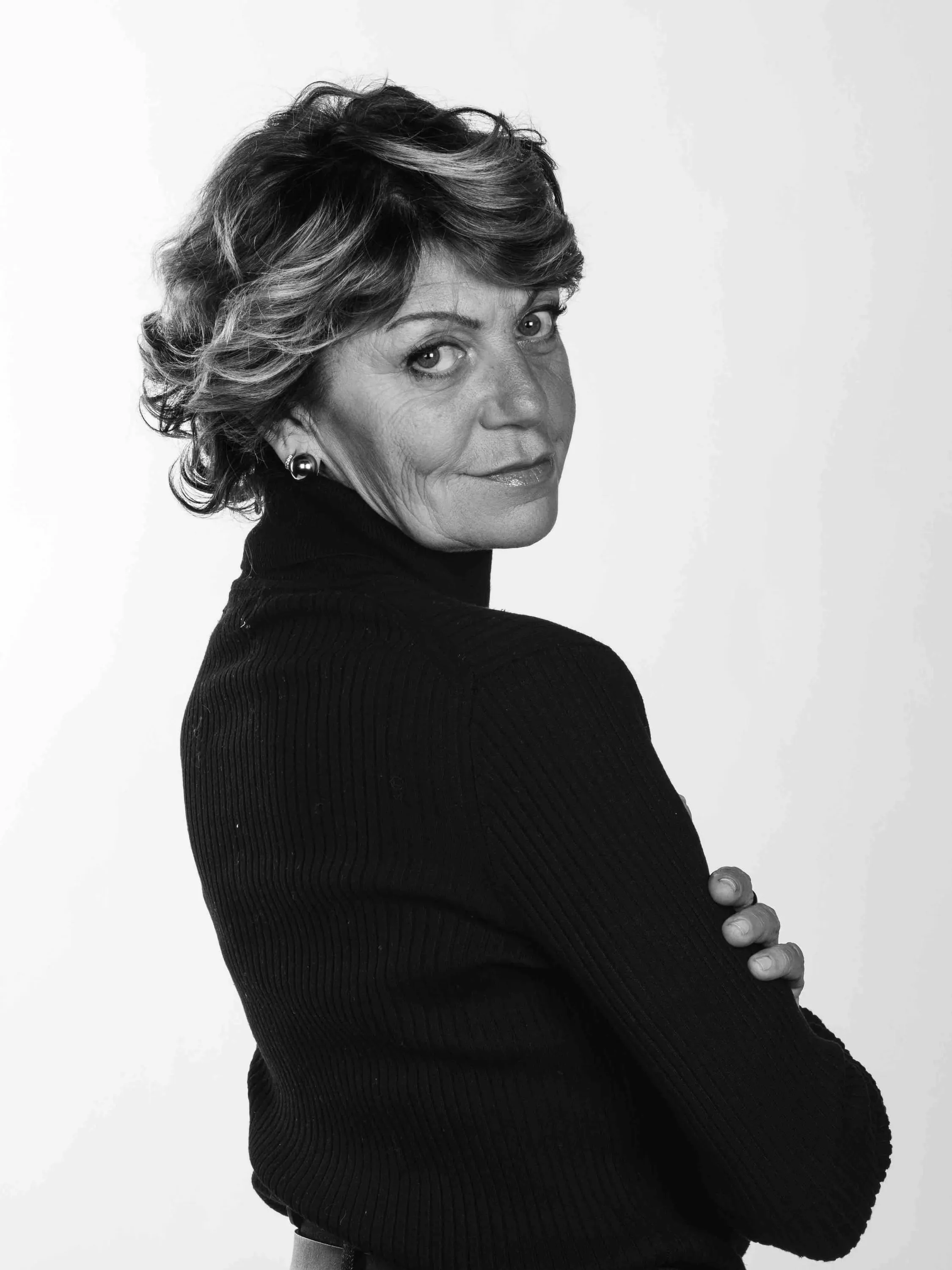 Black-and-white portrait of the make-up artist looking over her shoulder