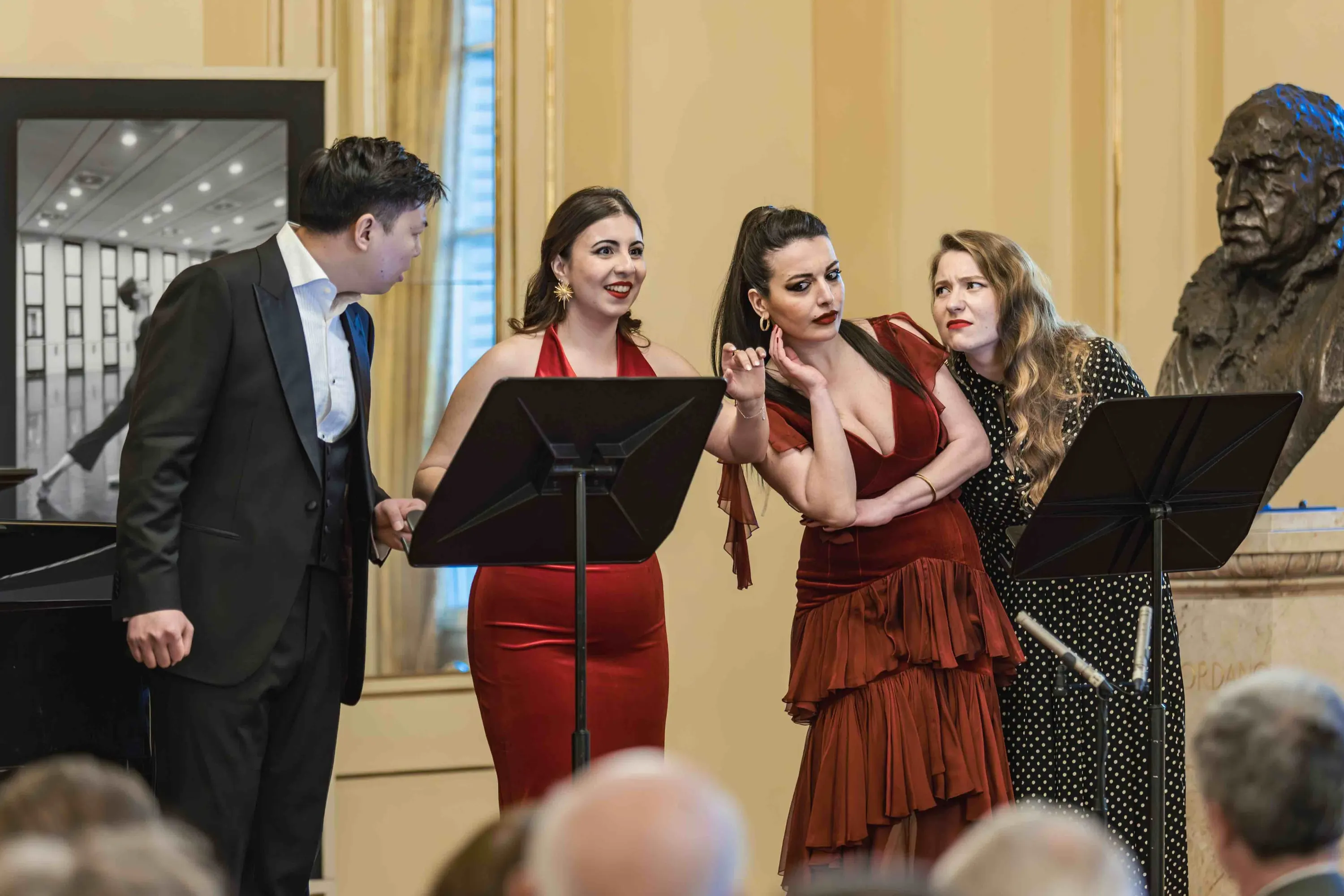 Four singers at their music stands during the concert